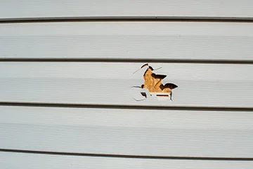 A worker coating roof with silicon